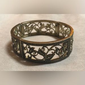 Gold tone cuff bracelet.